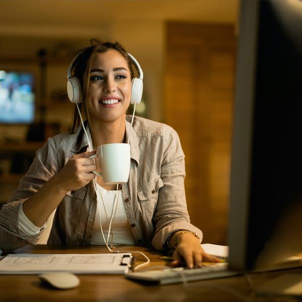 Woman on laptop wearing headphones