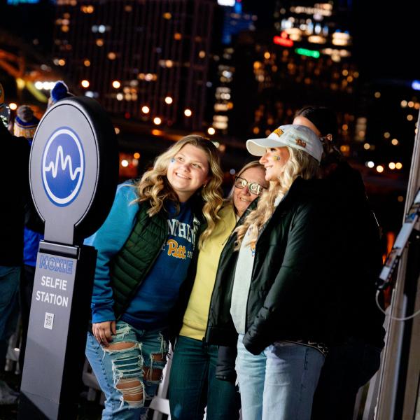 Three women all with blonde hair smiling for a photo