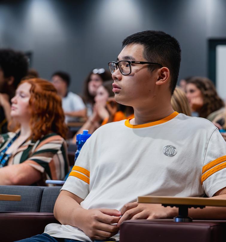 Student sitting at a desk in a classroom.