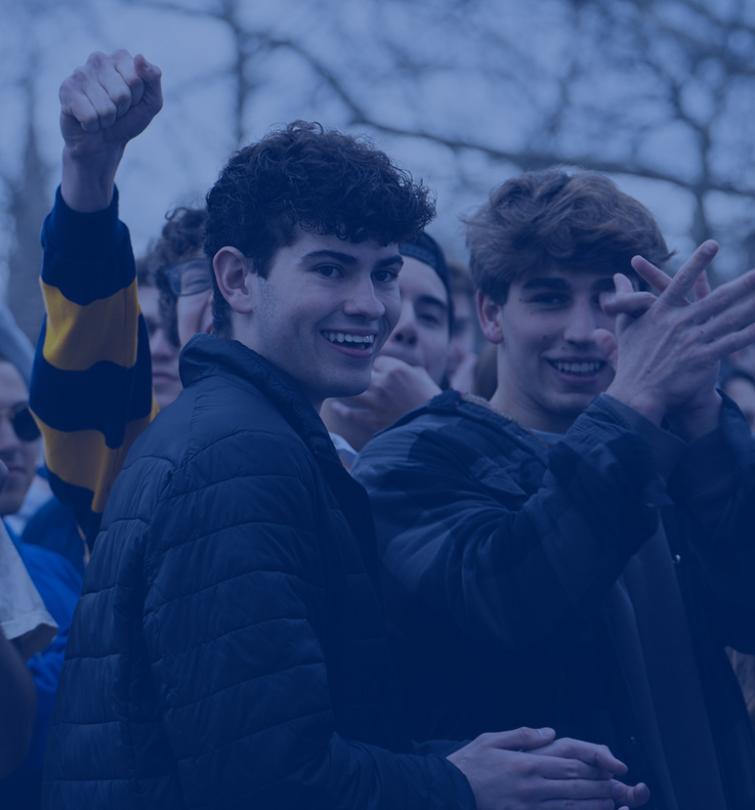 Students clapping in a crowd.