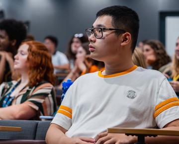 Student sitting at a desk in a classroom.