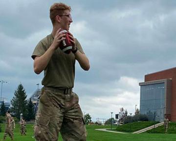 Cadet playing catch with football