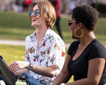 Students smiling outside on campus.